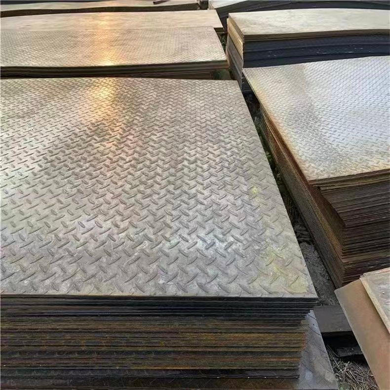 Stacks of metal checker plates with raised surface patterns